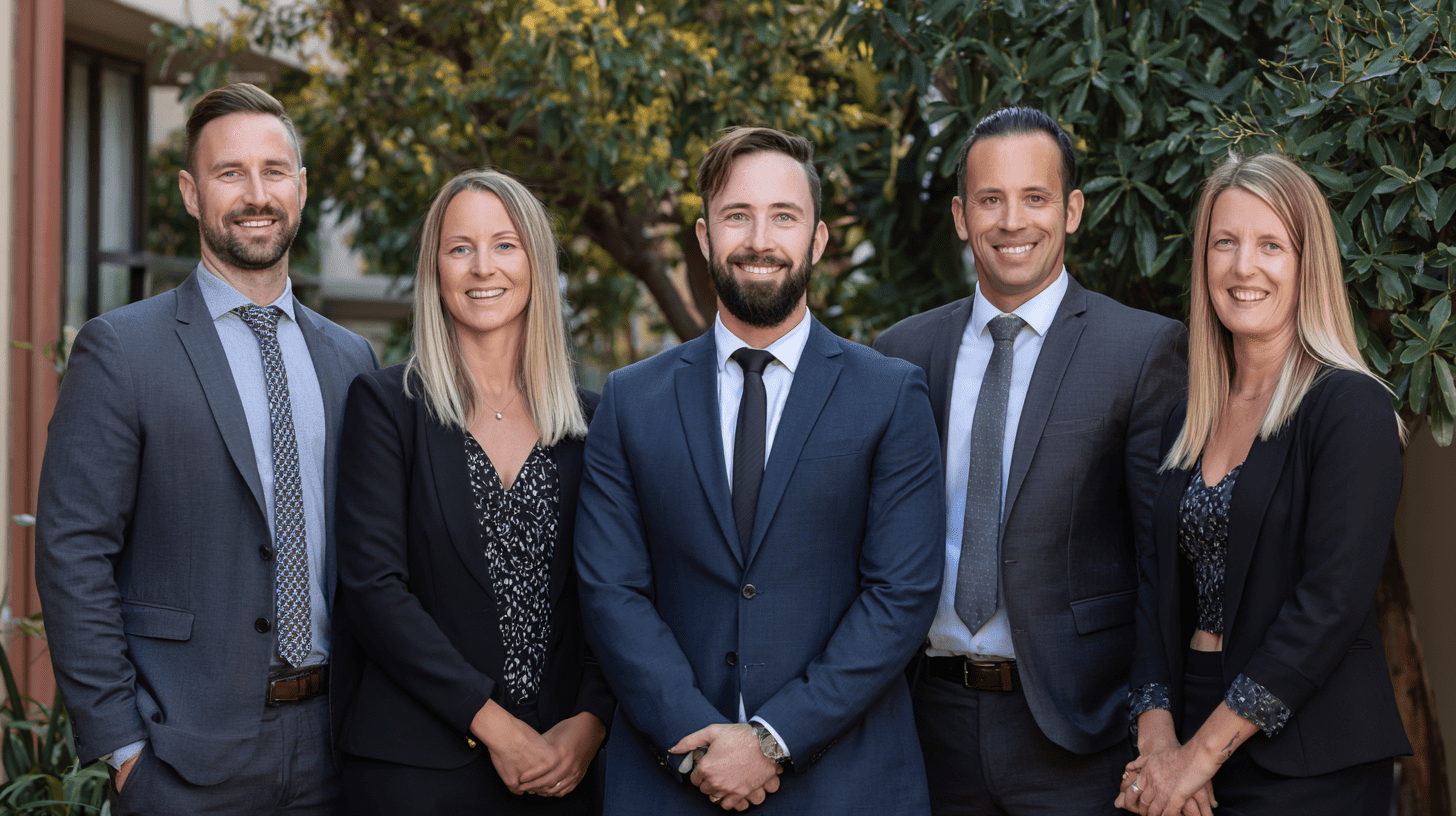 A team of personal injury lawyers posing for a team photo outside their office in Ryde, Sydney.