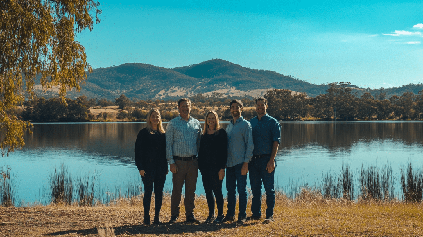 A team of accountants posing for a team photo near Lake Wodonga in Albury-Wodonga.