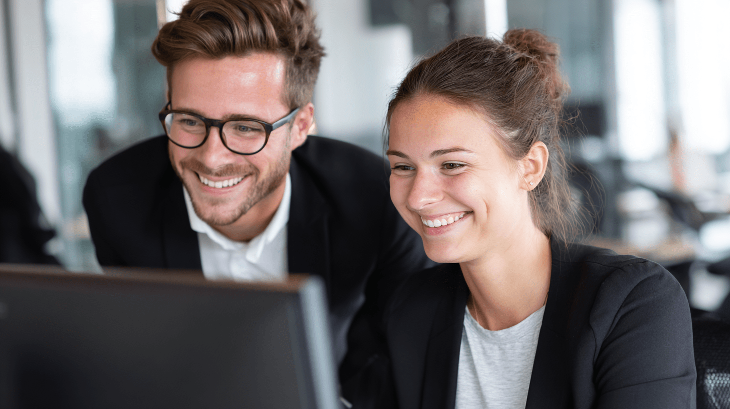 Two accountants reviewing their SEO analytics on a computer in their office.