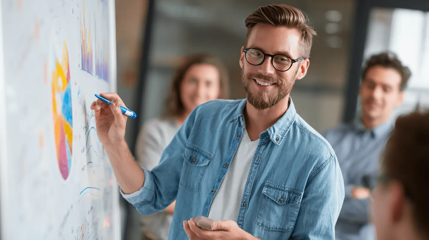 A manager explaining a chart on a whiteboard to his work colleagues.