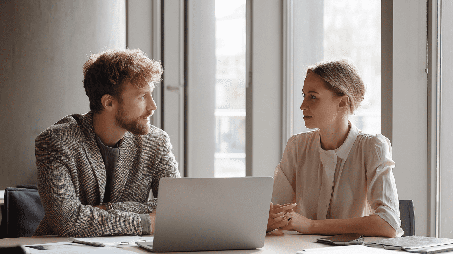 Two real estate agents discussing their home buying guides SEO in their office.