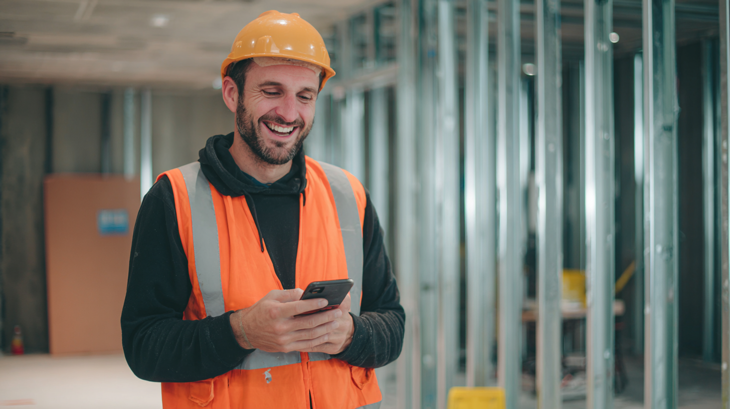 A retail fitout contractor looking at his social media on his mobile phone.